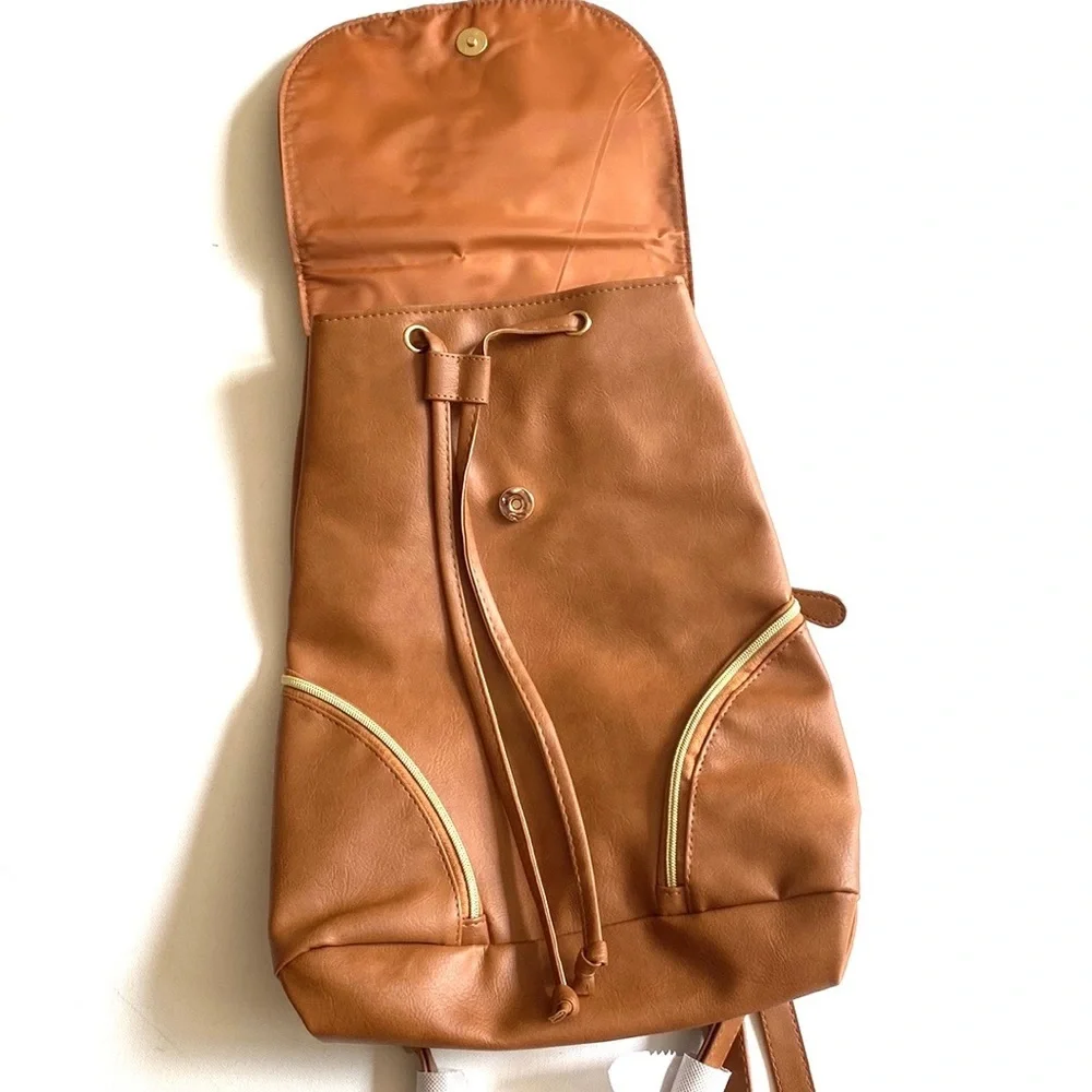 Brown backpack with zipper‎ accented detailing on front, NWOT
